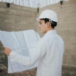 Architect examining blueprints at a construction site in Mexico.
