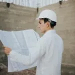 Architect examining blueprints at a construction site in Mexico.